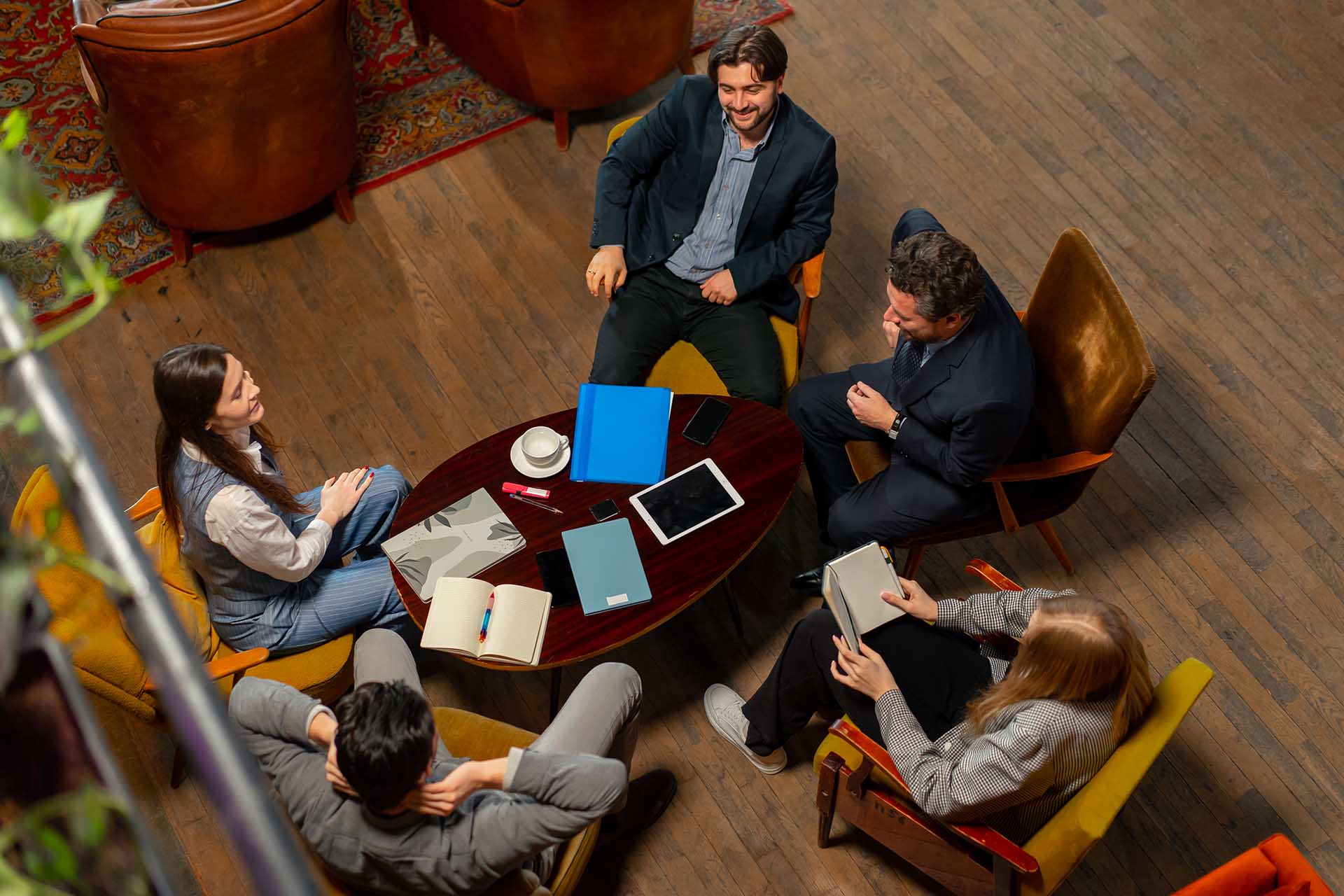 top shot in large beautiful hall office employees sitting on yellow chairs discuss a deal